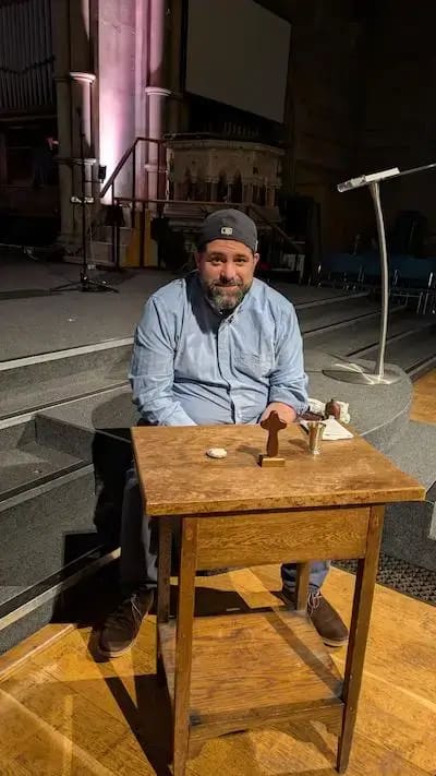 Thomas sat at the Communion table