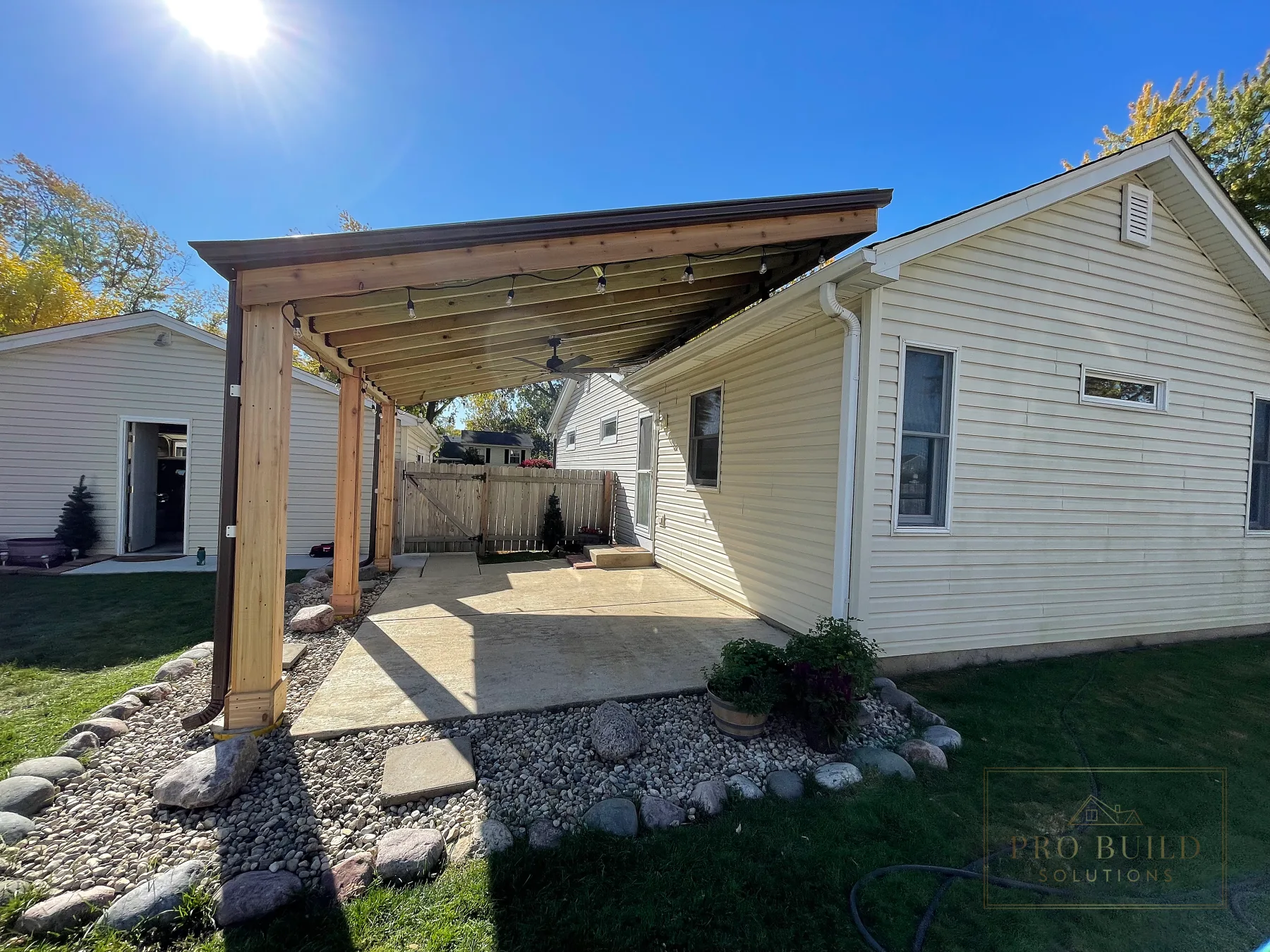 Side view of gray metal roof and raised roof profile on custom covered pergola in Rolling Meadows