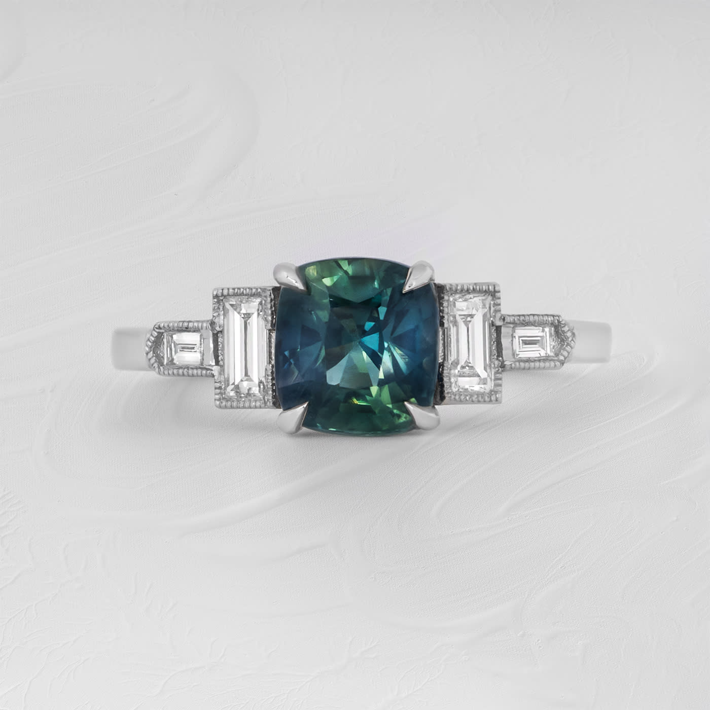 Cushion teal sapphire and baguette diamond ring