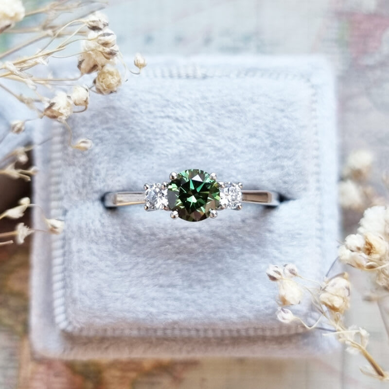Lab grown forest green diamond trilogy ring in platinum