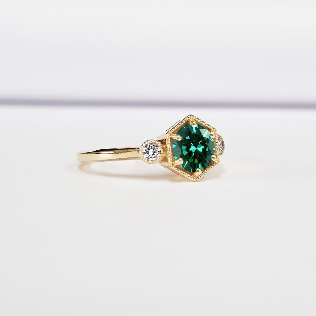 Teal green moissanite trilogy ring — 3