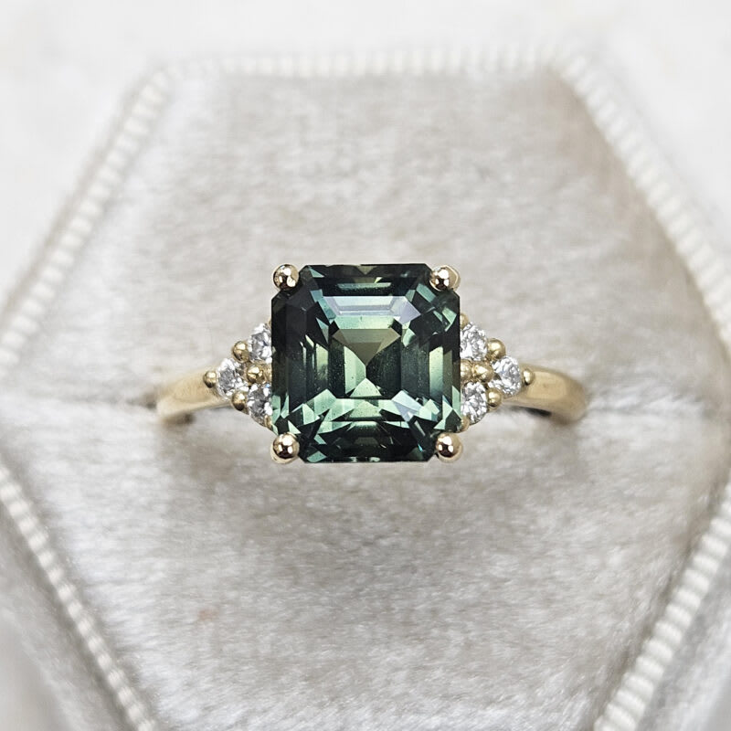 Emerald cut green sapphire and diamond ring