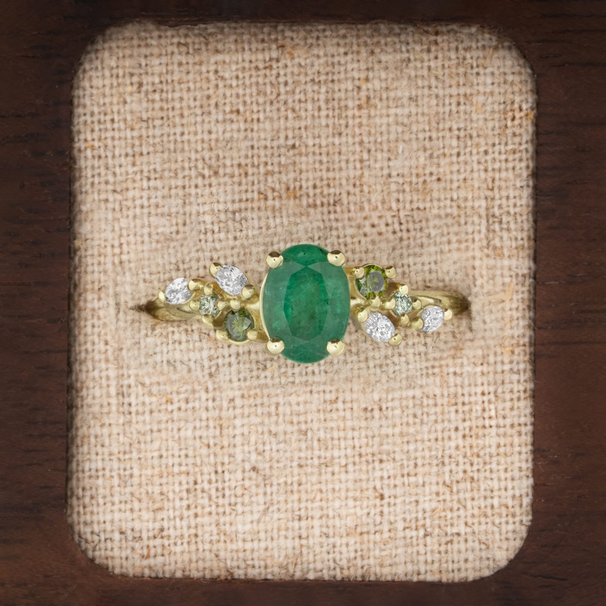 Emerald and diamond ring in green gold
