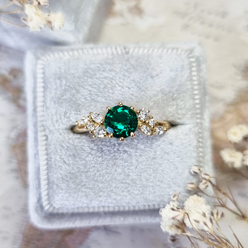 Round emerald and diamond cluster ring