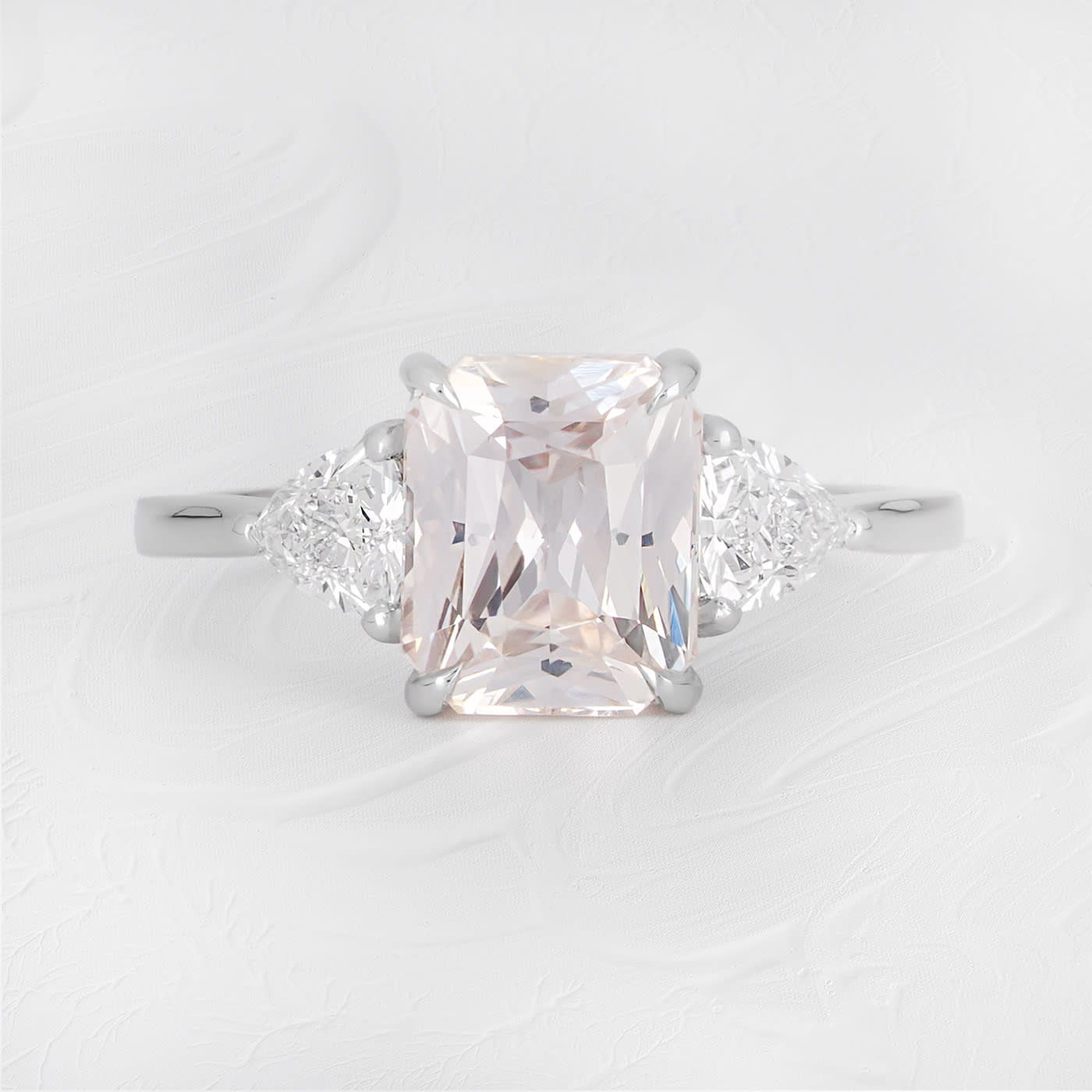 Emerald cut peach sapphire and trillion diamond ring — 1