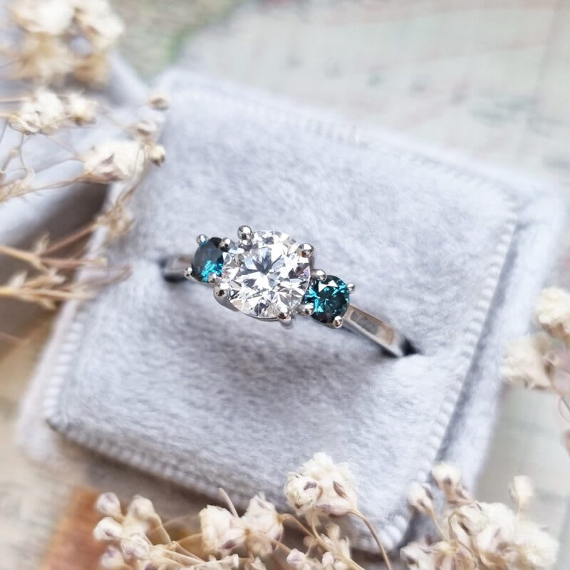 Lab grown teal diamond trilogy ring in platinum — 2