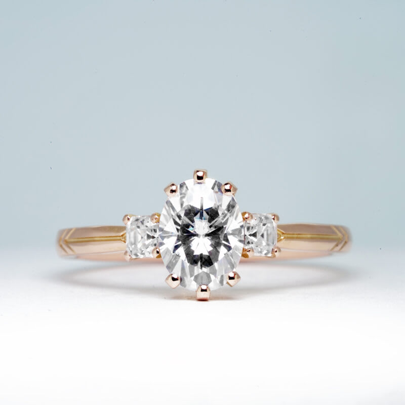 Oval and asscher moissanite trilogy engagement ring