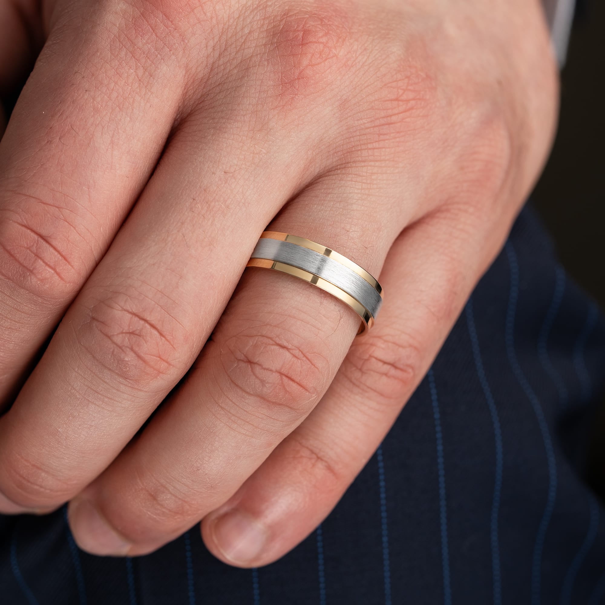 Two tone stepped edge wedding band 