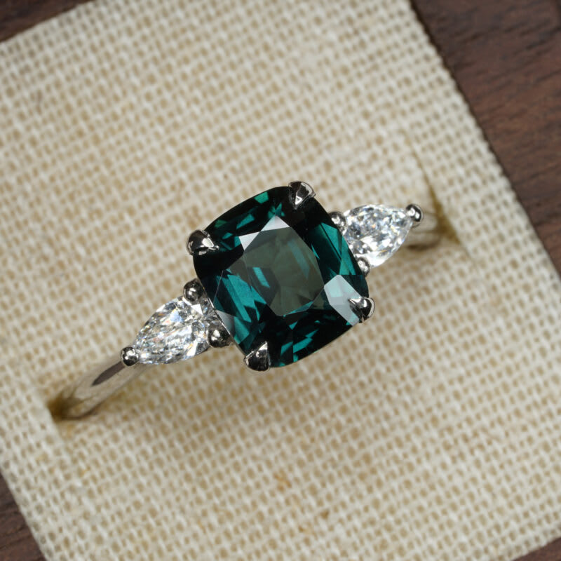 Deep teal cushion sapphire and diamond trilogy ring — 1