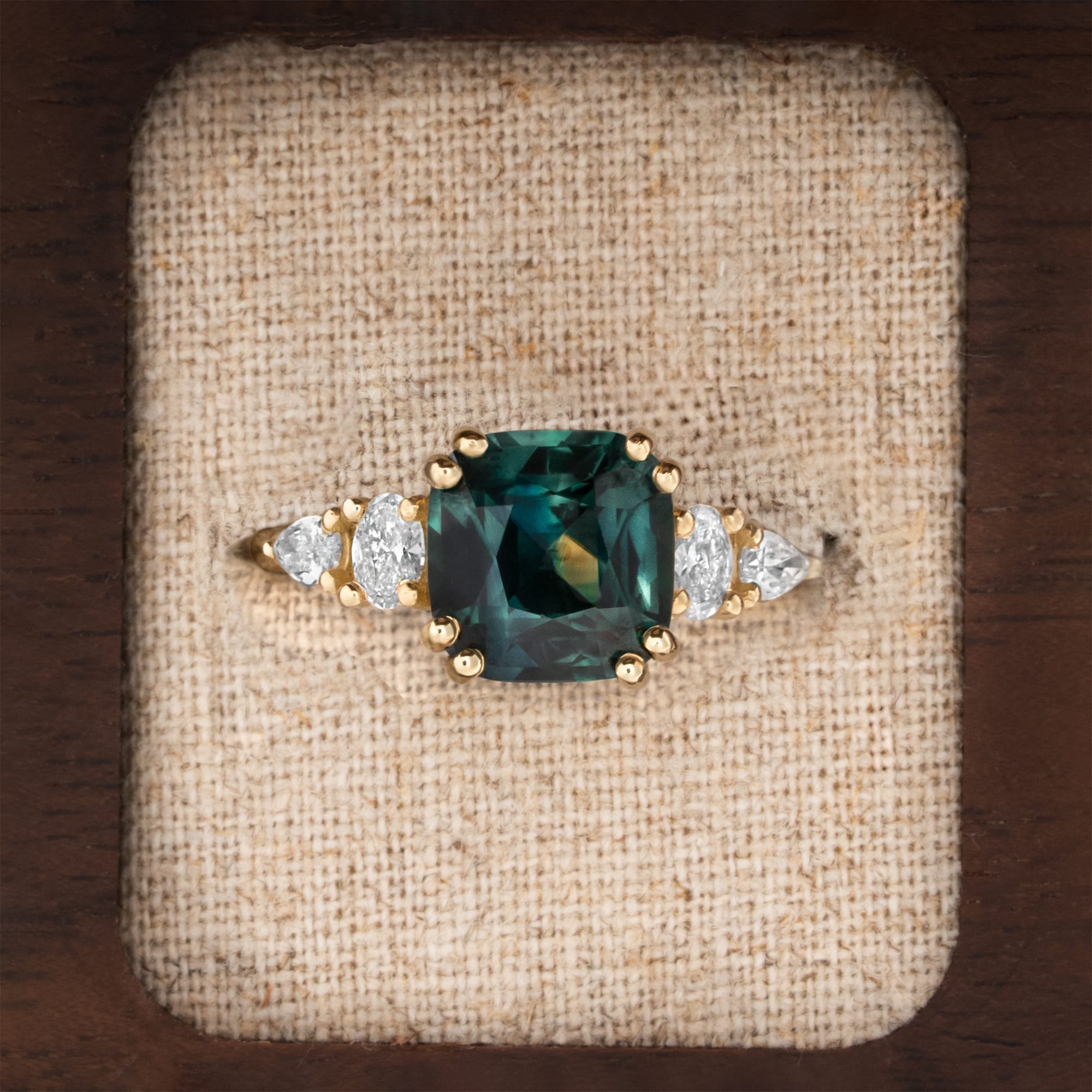 Cushion teal sapphire and diamond ring