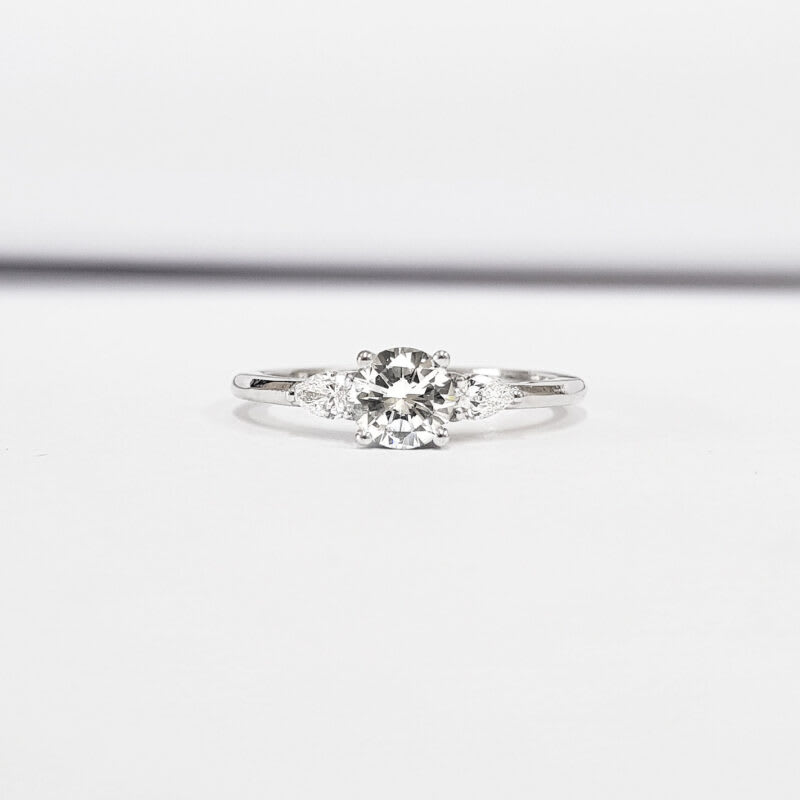 Moissanite and pear diamond trilogy ring