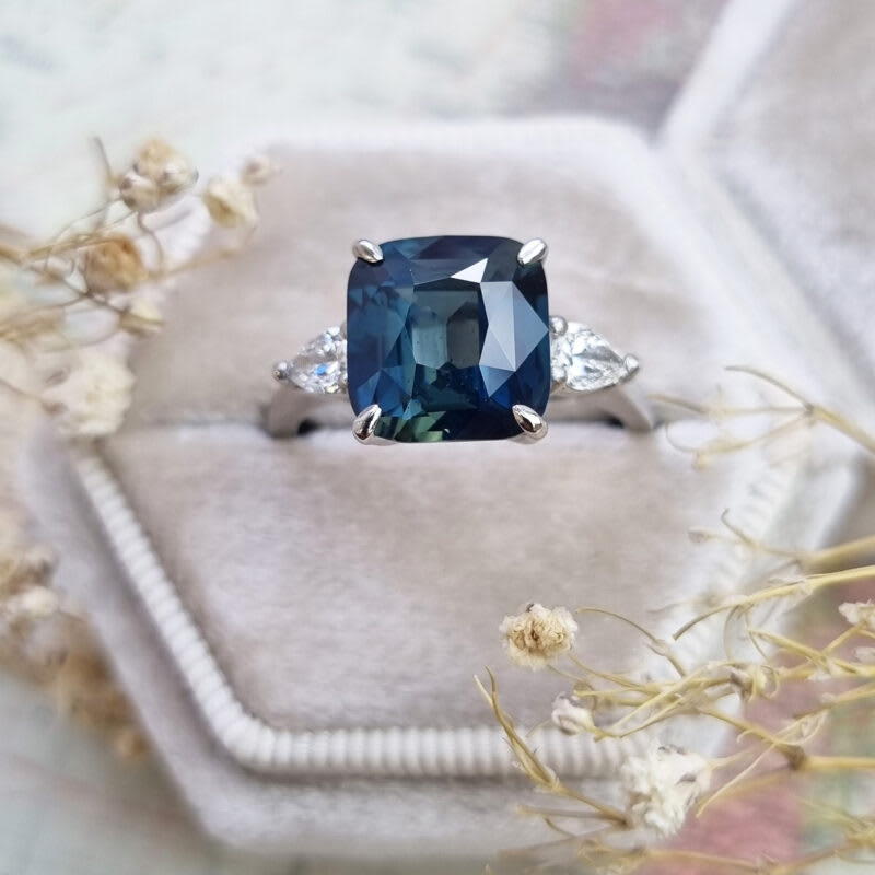 Cushion teal sapphire and diamond trilogy ring in platinum — 1