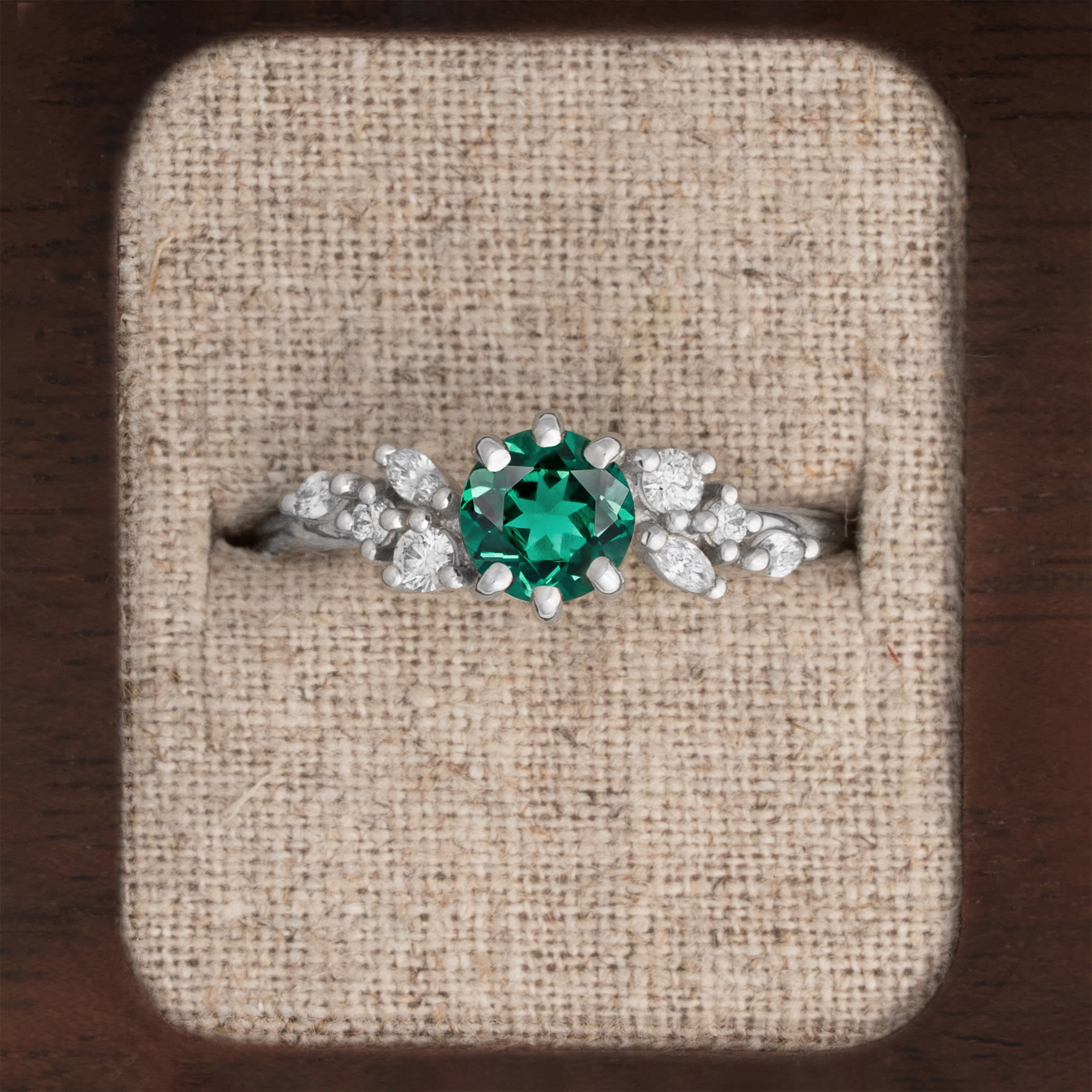 Round emerald and diamond cluster ring