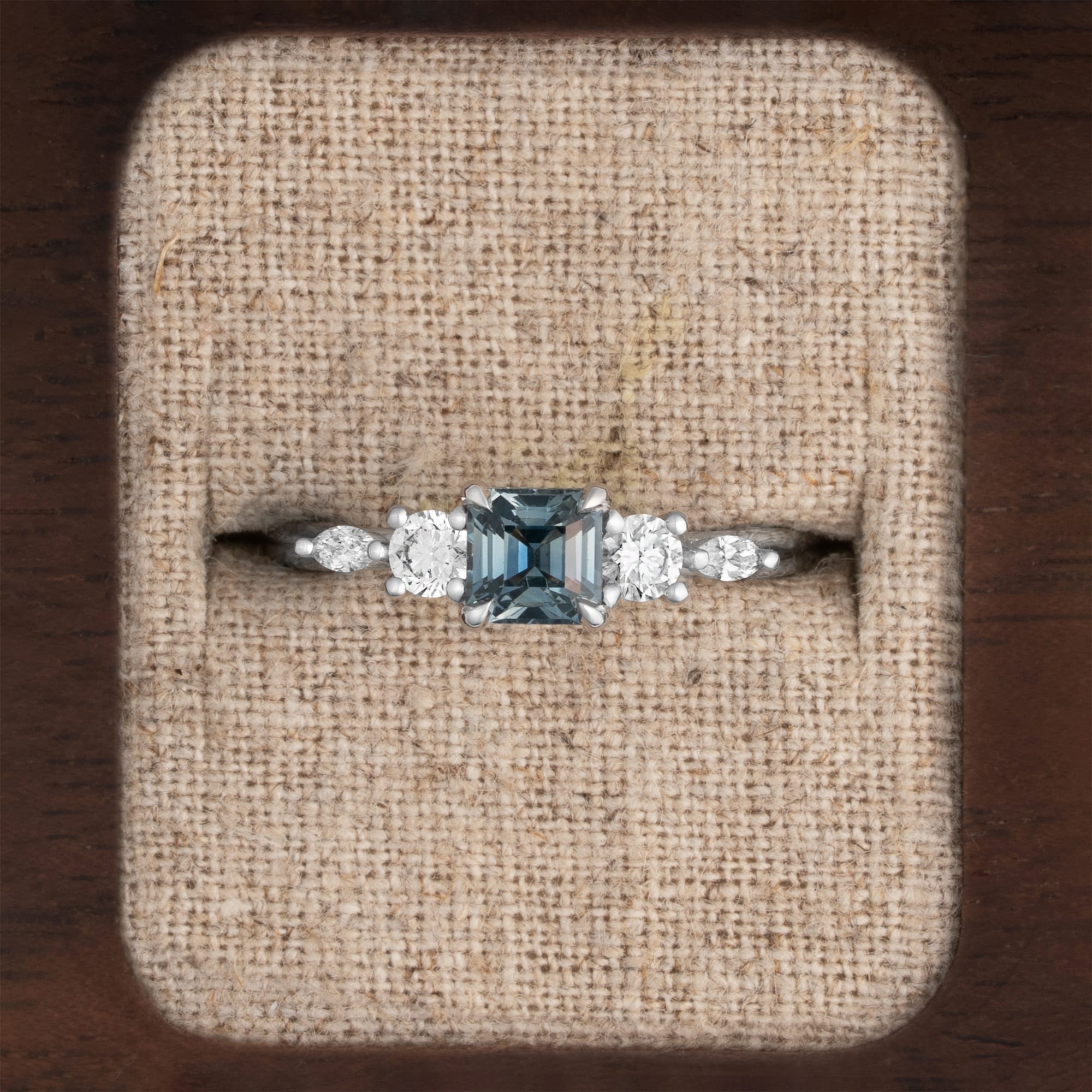 Emerald cut steely teal sapphire and diamond trellis ring 