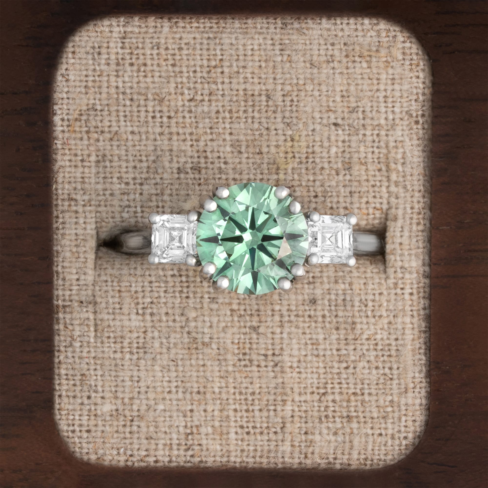 Lab grown green diamond trilogy ring in platinum