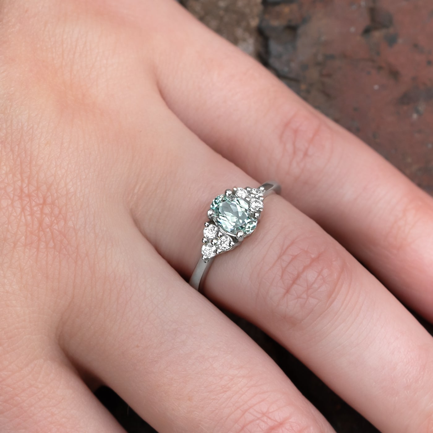 Oval lab grown seafoam green sapphire and diamond ring