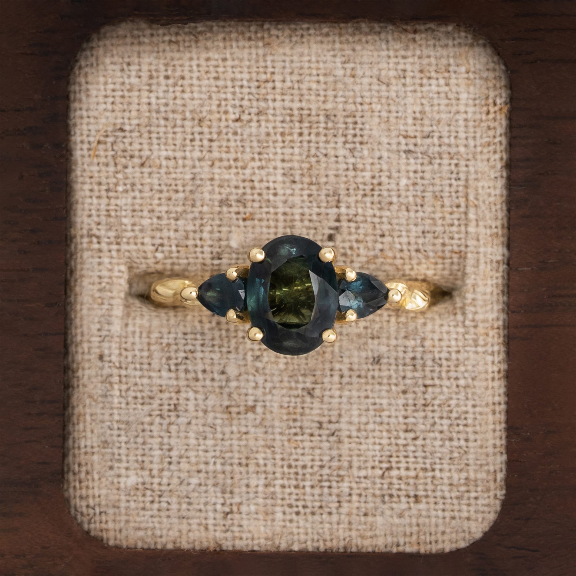 Teal sapphire trilogy ring