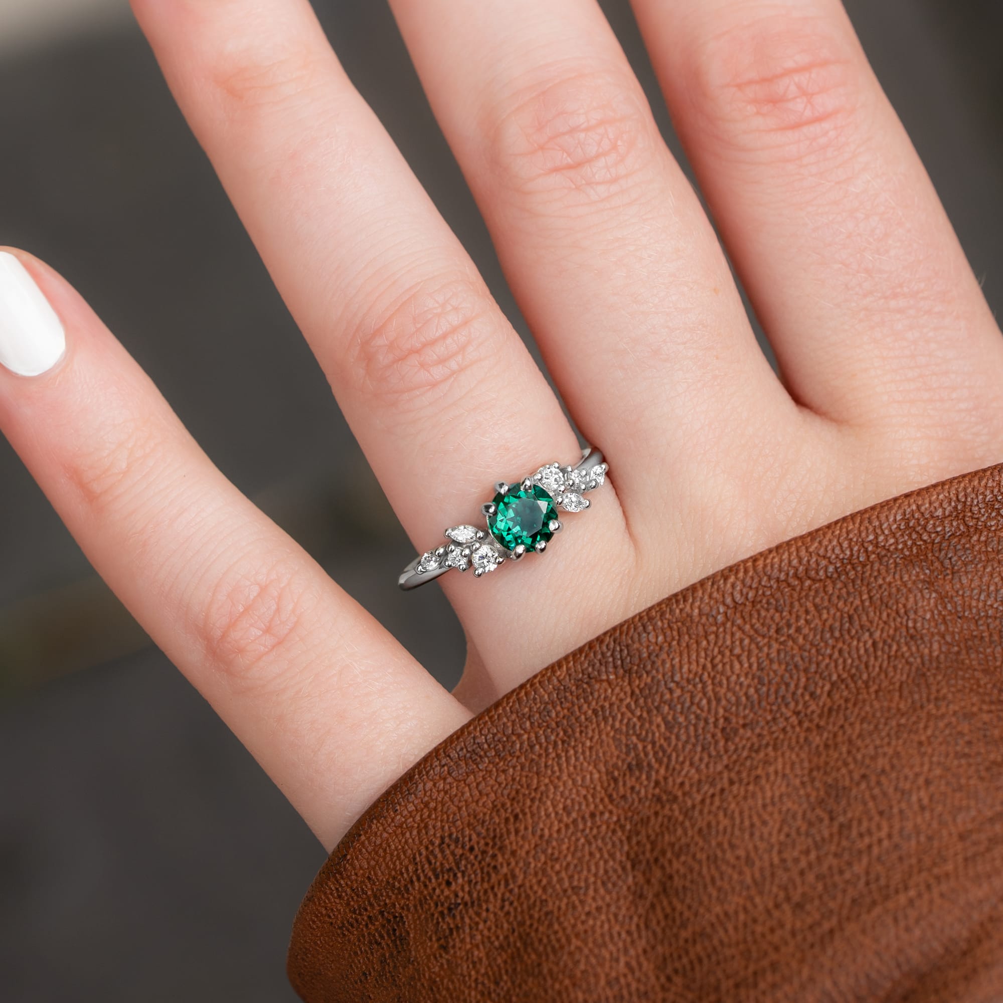 Round emerald and diamond cluster ring