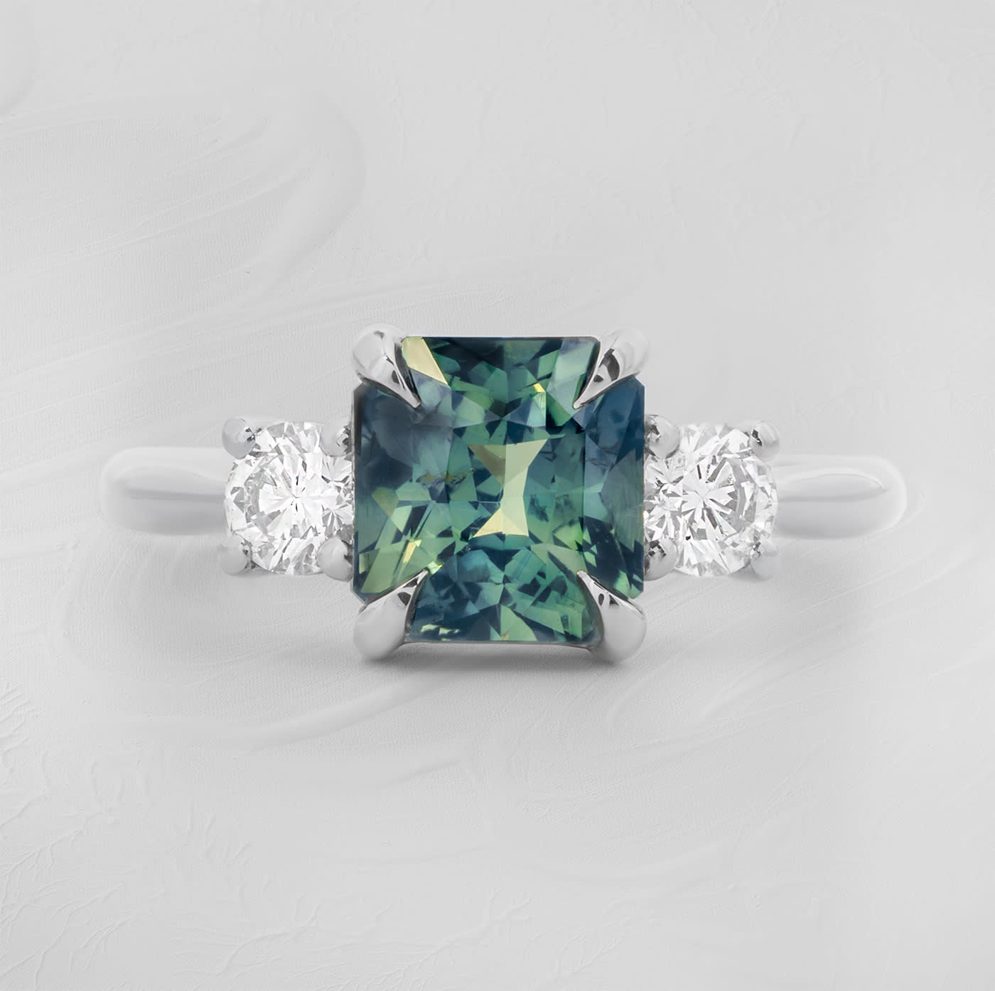 Radiant cut teal sapphire and diamond trilogy ring product image