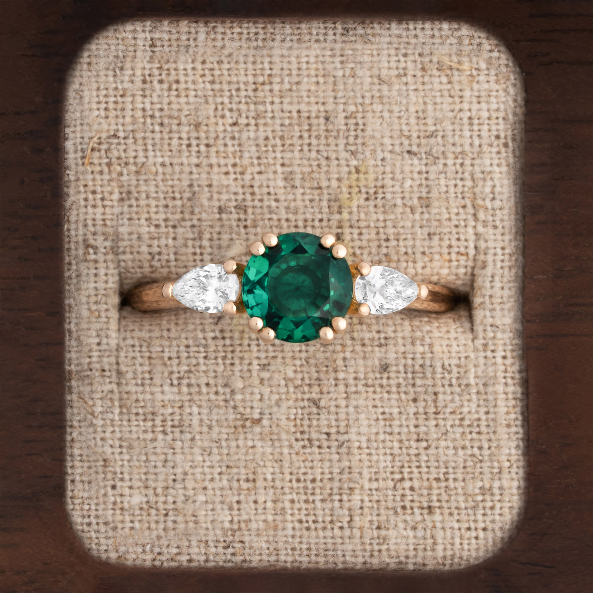 Lab emerald and pear diamond trilogy ring