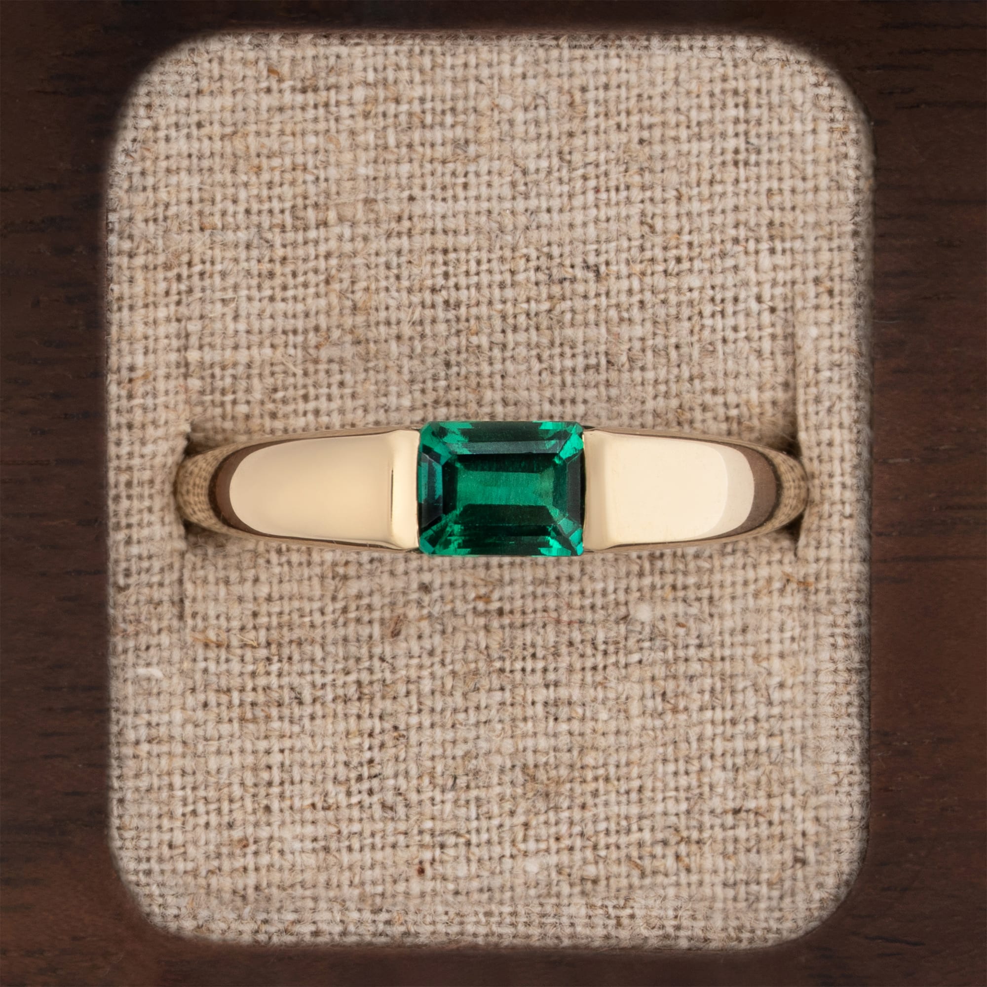 Channel set emerald tapered band