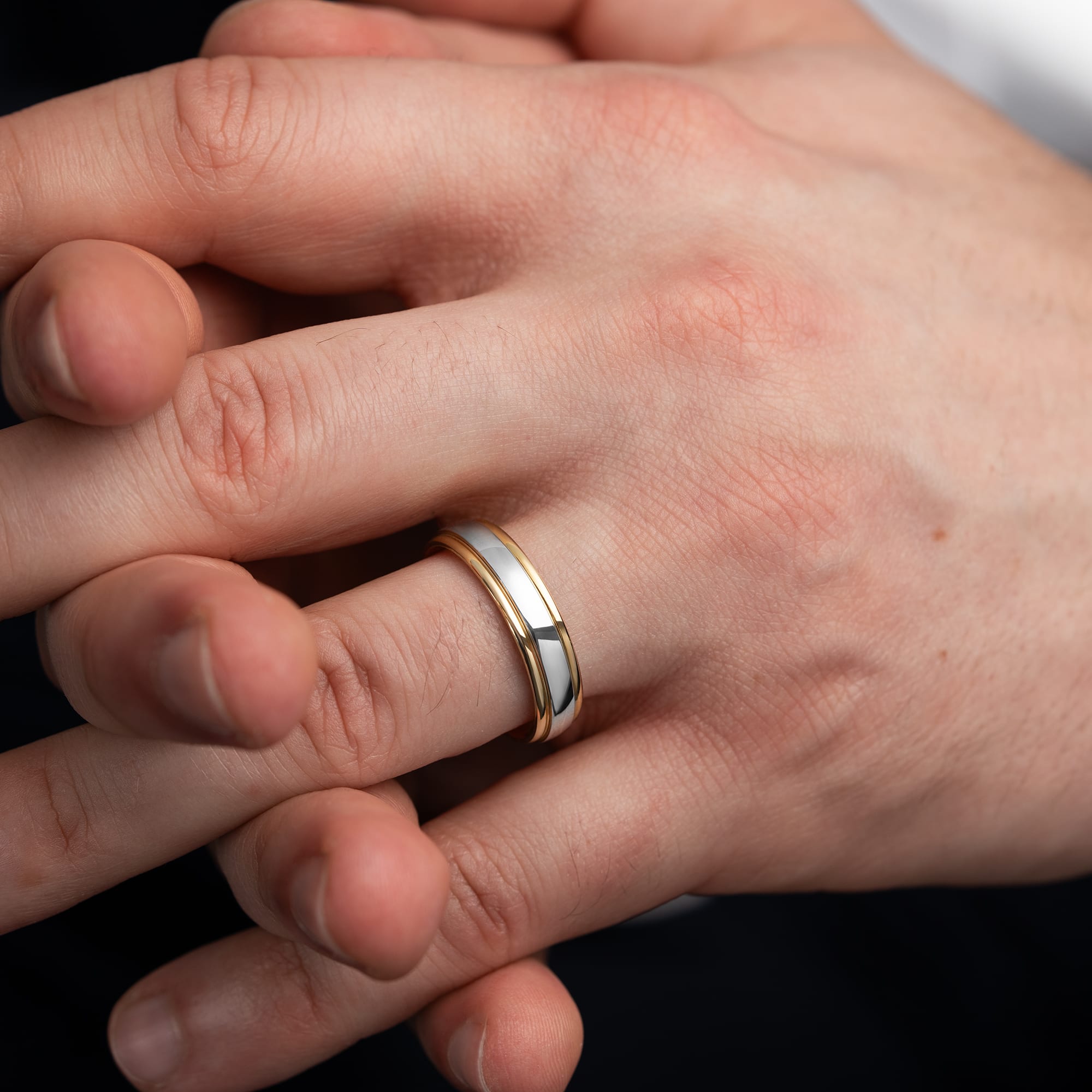 Two tone stepped edge wedding band