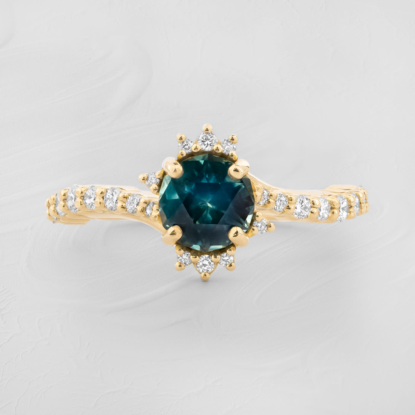 Intense precision cut deep teal sapphire and diamond twist ring product image