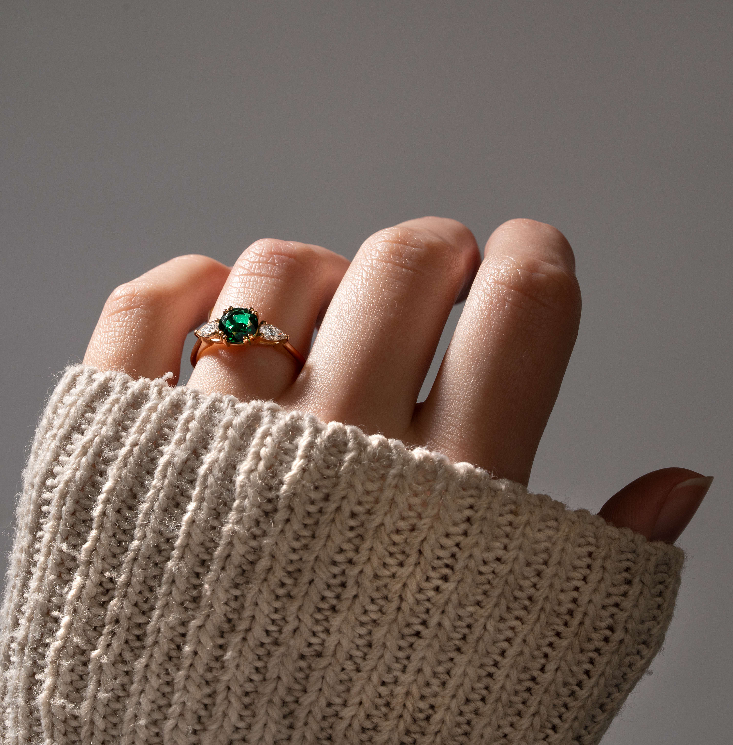 Lab emerald and pear diamond trilogy ring