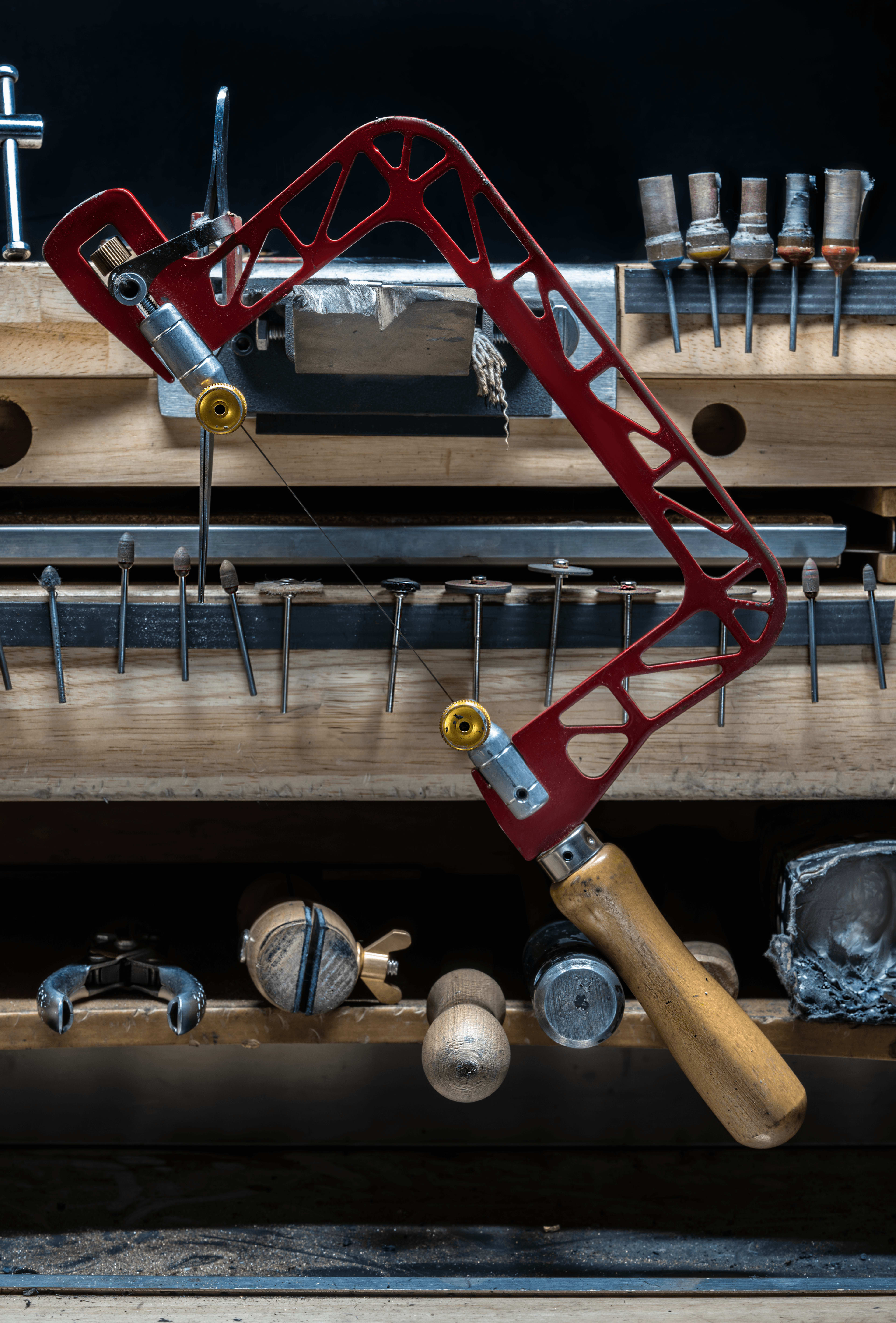 A jewellers bench featuring a hand saw
