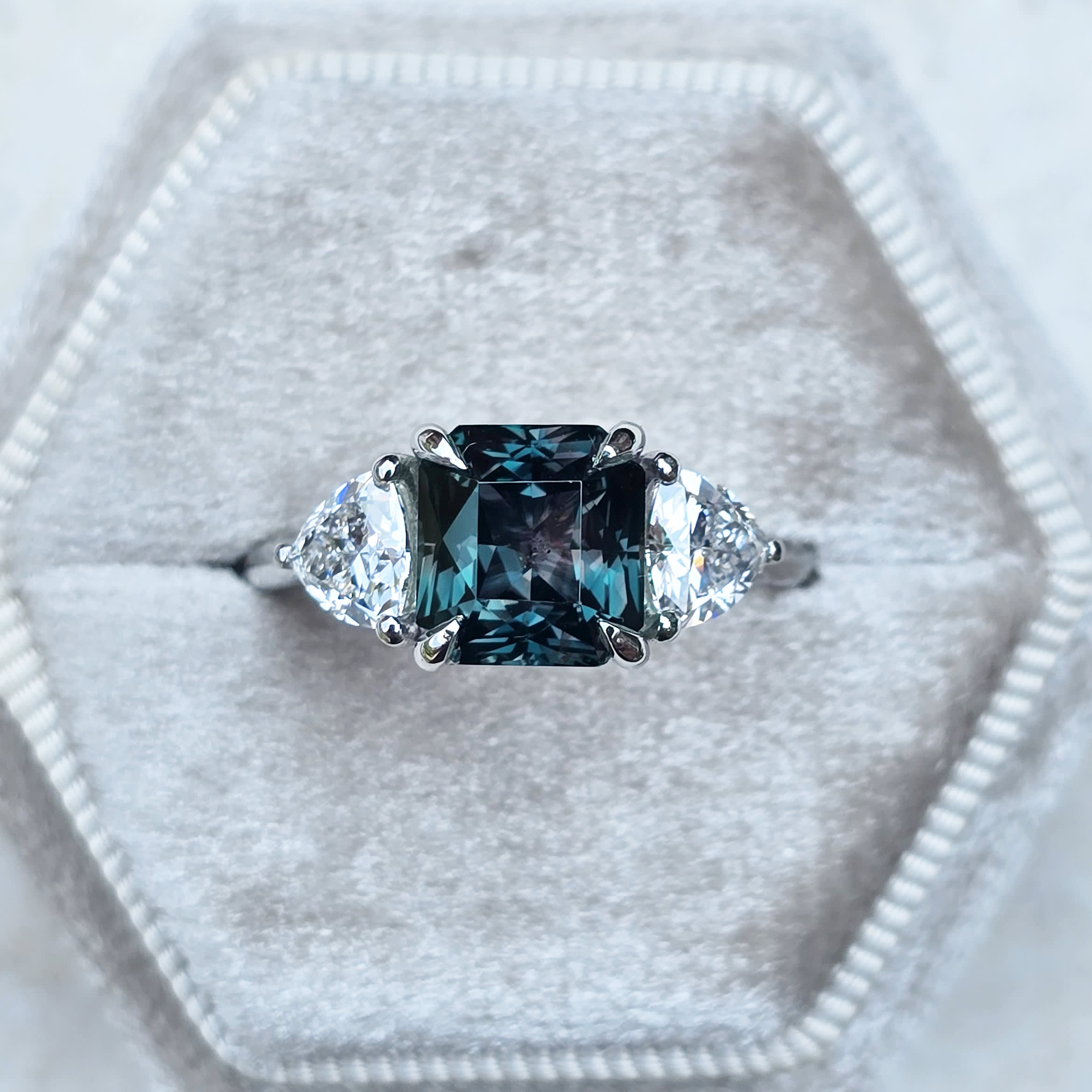 Radiant colour changing sapphire and trillion diamond ring