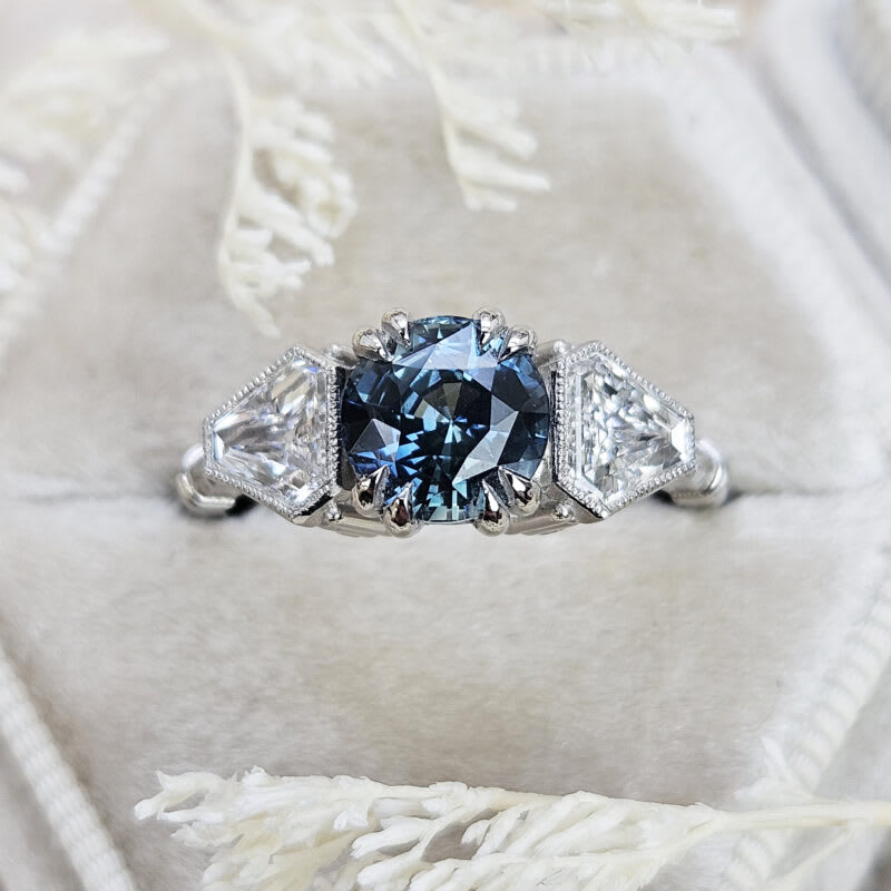 Icy sapphire and diamond oval engagement ring in platinum