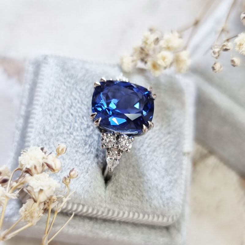 Cushion cut lab grown blue sapphire and diamond ring in platinum