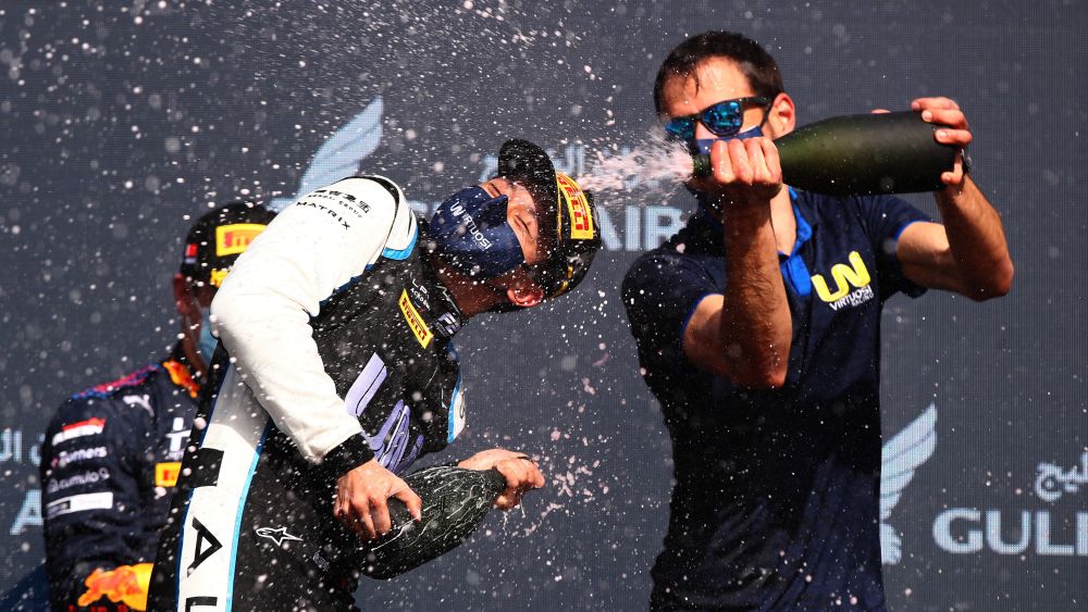 Rivera R and Zhou L celebrating together on the podium after his first Feature Race win in Sakhir