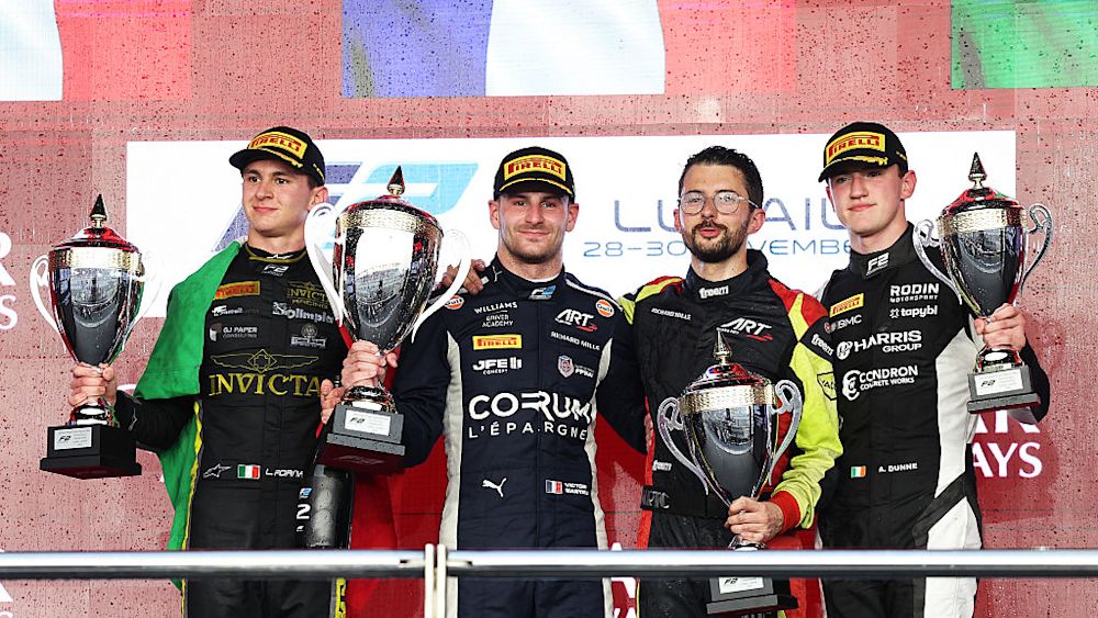 The top three celebrate on the podium at the end of the Feature Race