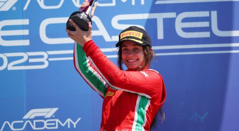 Marta Garcia puts one hand on the trophy after Race 2 win