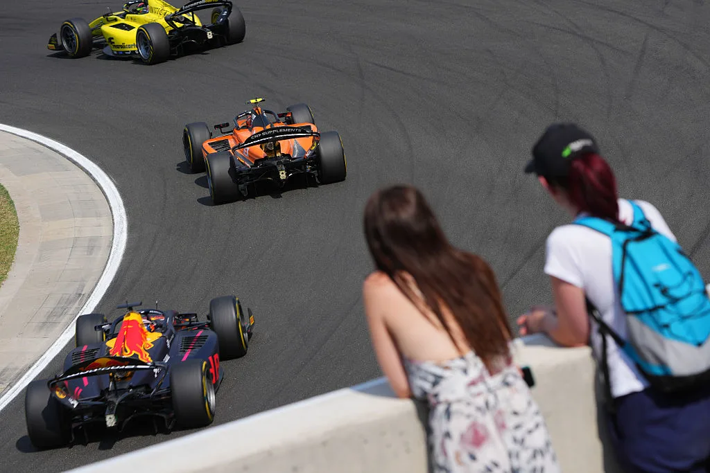 Formula 2 cars race past spectators at the Hungaroring during the Budapest weekend