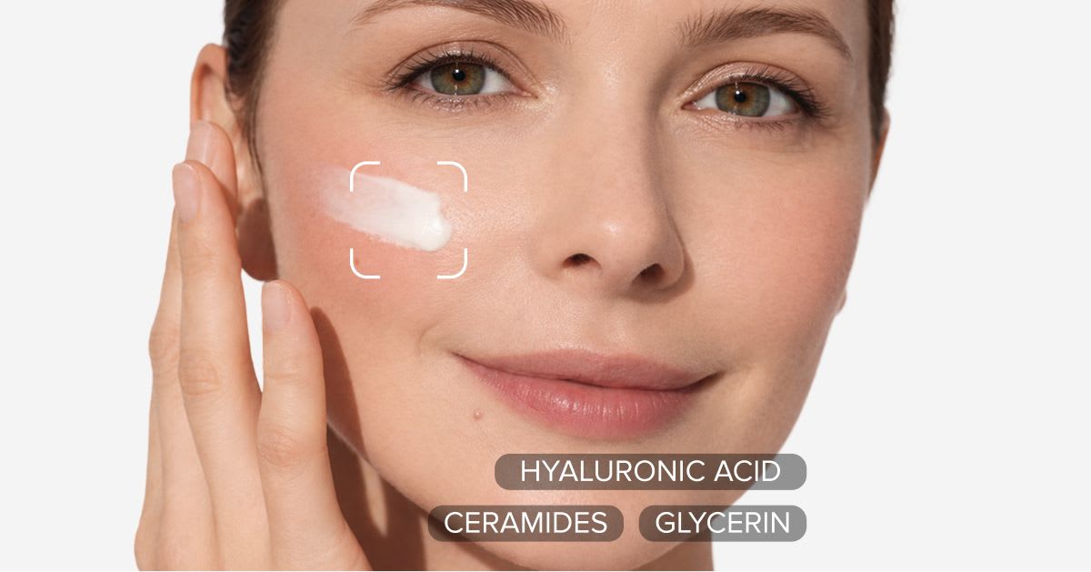 Woman applying a cream sunscreen to her cheek, with key ingredients labeled: hyaluronic acid, ceramides, and glycerin.