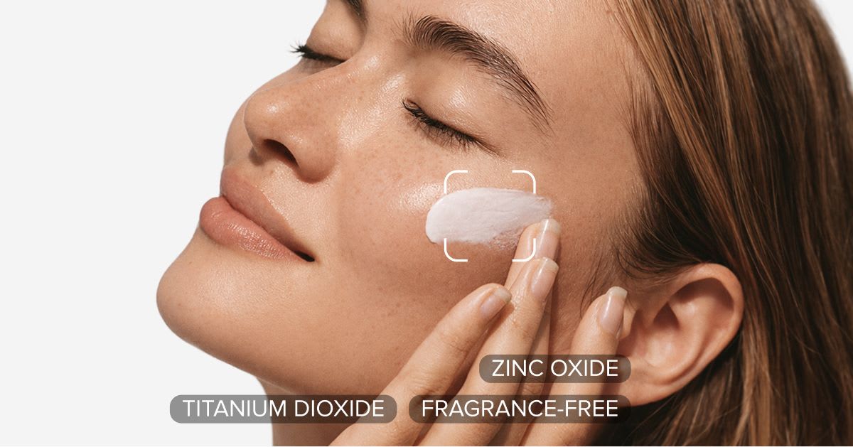 Woman applying a mineral sunscreen to her cheek, with key ingredients labeled: zinc oxide, titanium dioxide, and fragrance-free.
