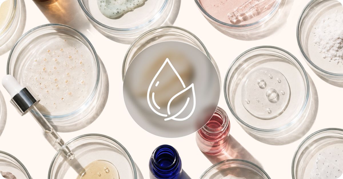 Top-down view of petri dishes containing various skincare textures and powders alongside a glass dropper and small bottles, representing clean and safe cosmetic formulations.