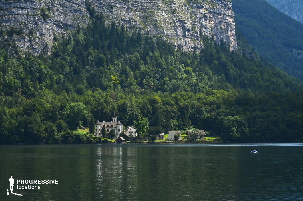 This breathtaking location features a white fairytale-style castle nestled at the edge of a calm lake, framed by dense forest and backed by a towering vertical rock wall. The harmony between the architecture, lush greenery, and sheer cliff creates a composition rich in contrast and scale. With its cinematic reflection in the water and secluded atmosphere, this setting is ideal for fantasy, historical drama, or mystery genres. It’s perfectly suited for scenes involving remote estates, hidden aristocratic enclaves, or magical retreats.