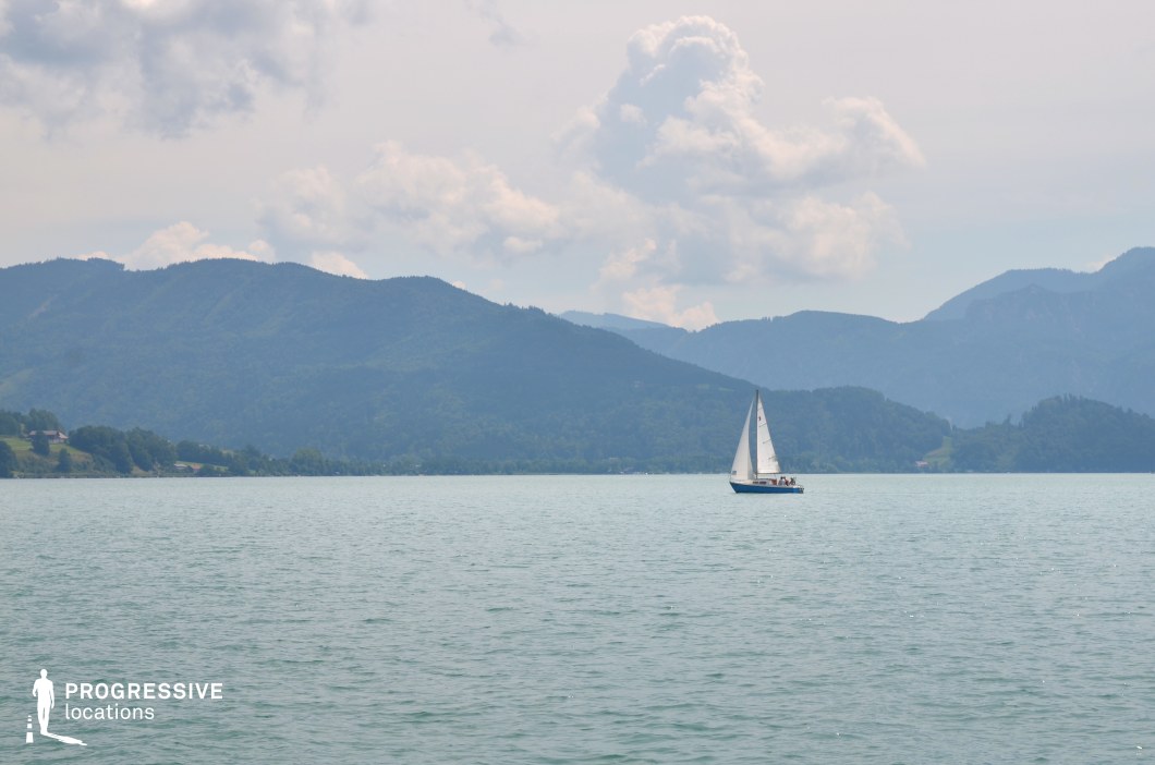 This wide, open lake scene features calm, reflective water bordered by softly contoured mountain ridges in the distance. The clean composition and muted color palette create a tranquil, minimalist setting that evokes serenity and freedom. The expansive water surface offers a strong sense of scale and isolation, perfect for long tracking shots or symbolic visuals. This location is ideal for romantic dramas, introspective journeys, or coming-of-age films—especially scenes involving travel, emotional transitions, or moments of peaceful solitude in nature.