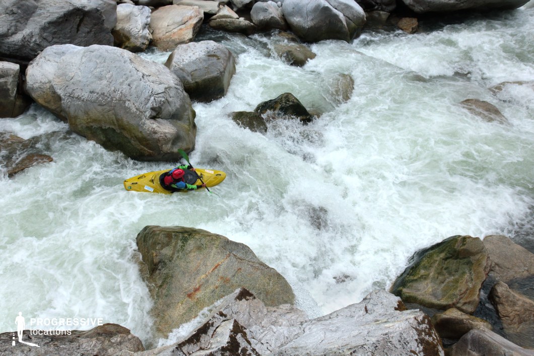 This dramatic natural setting showcases a narrow, boulder-strewn river gorge filled with fast-moving whitewater and large rocks jutting through the current. The rushing stream carves a dynamic, textured path through the rocky terrain, suggesting motion and raw energy. Ideal for filming high-adrenaline scenes in adventure or survival genres, this location is perfect for whitewater expeditions, escape sequences, or journeys through wild, untamed mountain landscapes.