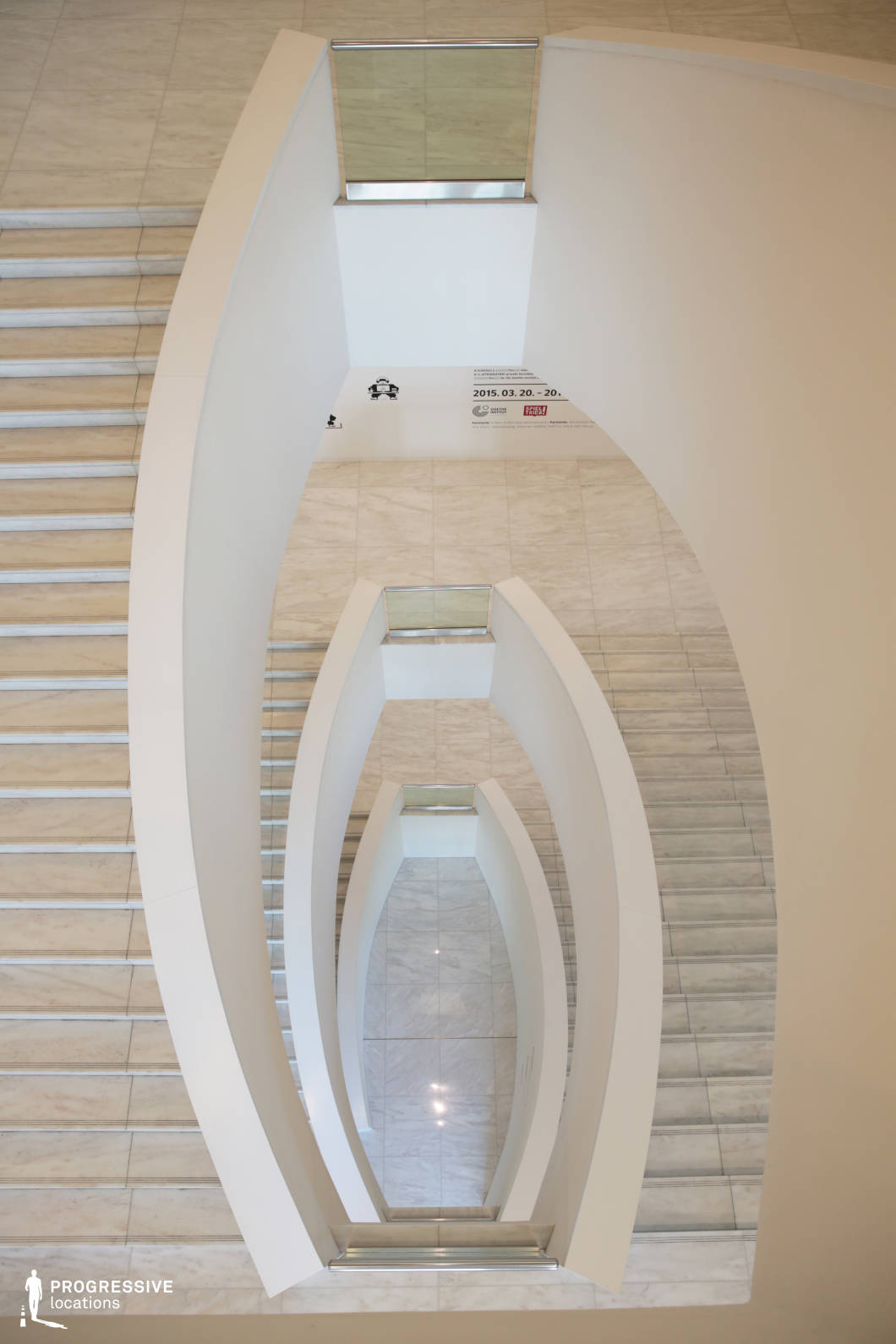 This sleek, modern staircase features an elegant spiral design with smooth, curving white walls and a polished marble finish that enhances the space’s minimalist aesthetic. The clean geometry and soft, diffused lighting create a sense of depth and fluidity, while the stainless steel and glass railings add a contemporary touch. The repetitive elliptical openings draw the eye downward, emphasizing the architectural symmetry and sculptural quality of the design. The fusion of simplicity and sophistication makes this staircase ideal for futuristic settings, high-end editorial shoots, or contemporary architectural projects requiring a refined and artistic backdrop.