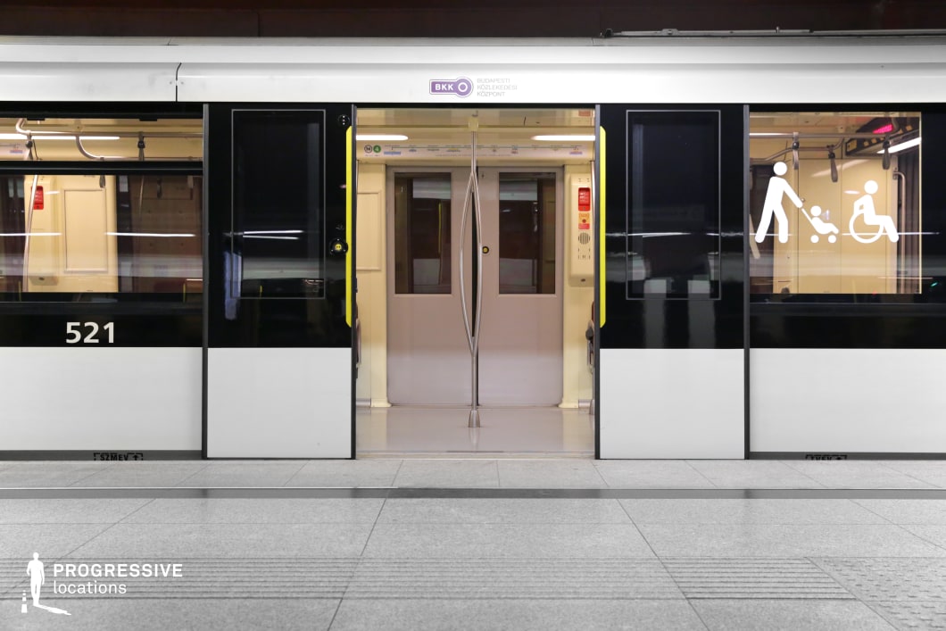 This metro train entrance features a sleek black-and-white exterior with accessibility symbols prominently displayed on the glass. The symmetrical composition highlights the open doors, revealing a well-lit interior with clean lines and functional design. Stainless steel details and smooth surfaces contribute to the contemporary aesthetic, making this setting ideal for commercial shoots, urban mobility campaigns, or futuristic transit sequences. The contrast between the dark window reflections and bright interior adds visual depth, emphasizing the accessibility and efficiency of modern public transport.