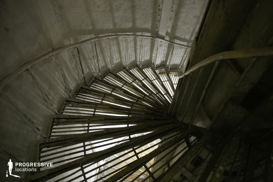 Spiral steel staircase in concrete shaft, a film and photography location with striking geometric design.