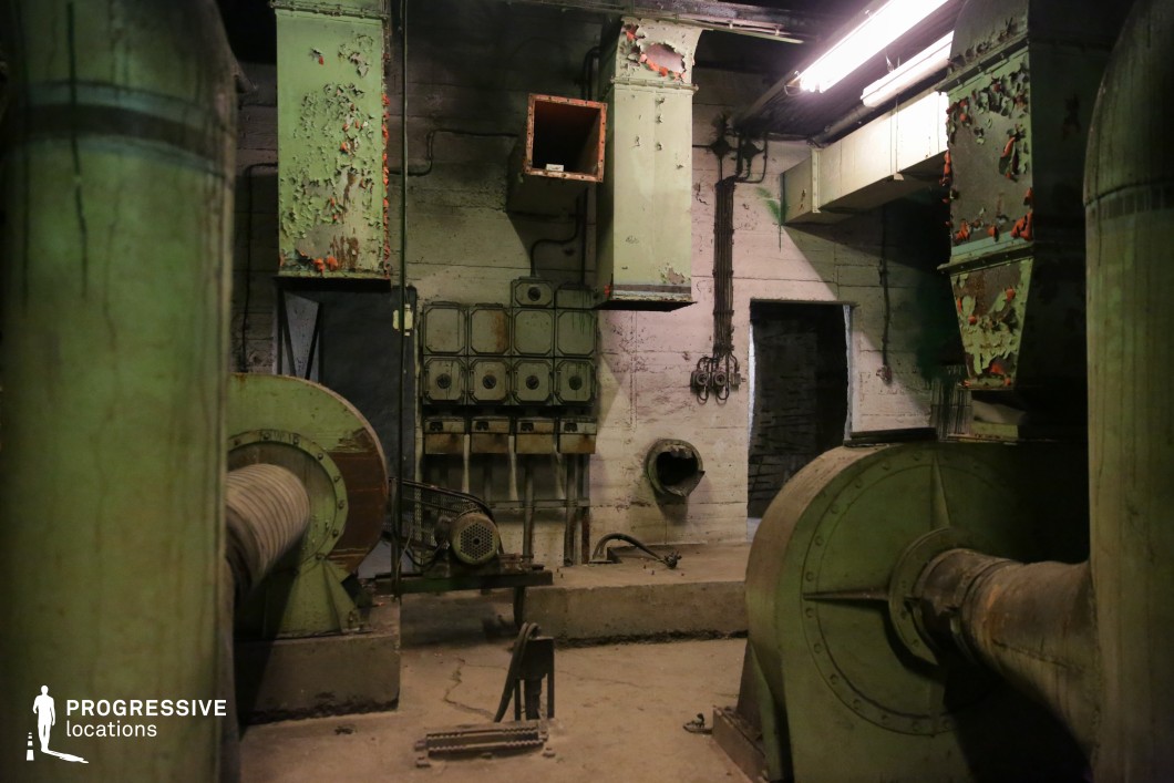 Industrial control room with ducts and fans, ideal film and photography location with aged mechanical details.