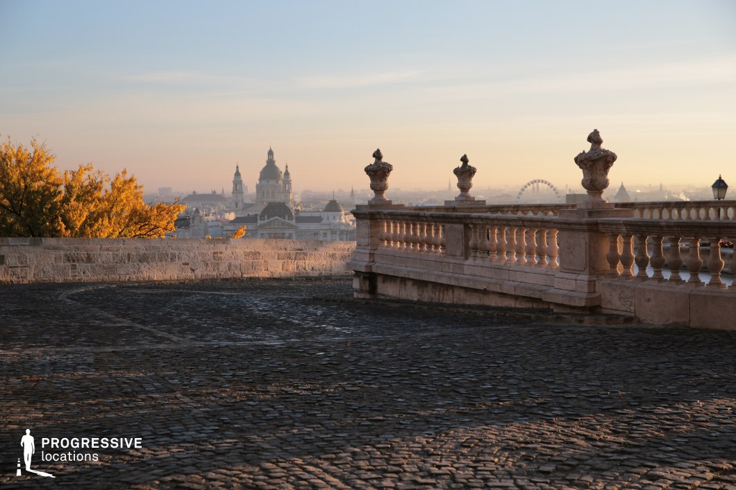This elegant stone terrace, adorned with intricate balustrades and decorative urns, offers a breathtaking panoramic view of the city's historic skyline. The cobblestone pavement in the foreground adds texture and old-world charm, complementing the soft silhouettes of domed churches and classical architecture in the background. The interplay of light and shadow enhances the depth and atmosphere of the location, making it an ideal setting for reflective, romantic, or historical film scenes that require a sense of grandeur and timelessness.
