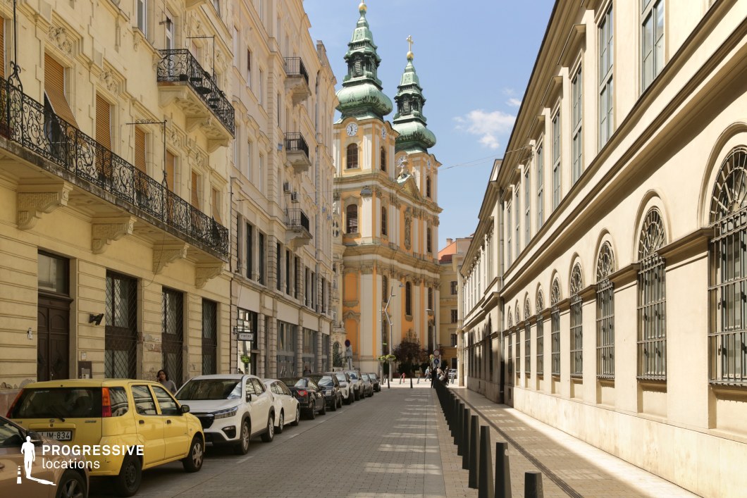 Historic street leading to baroque church towers, a film and photography location with strong axial composition and architectural depth