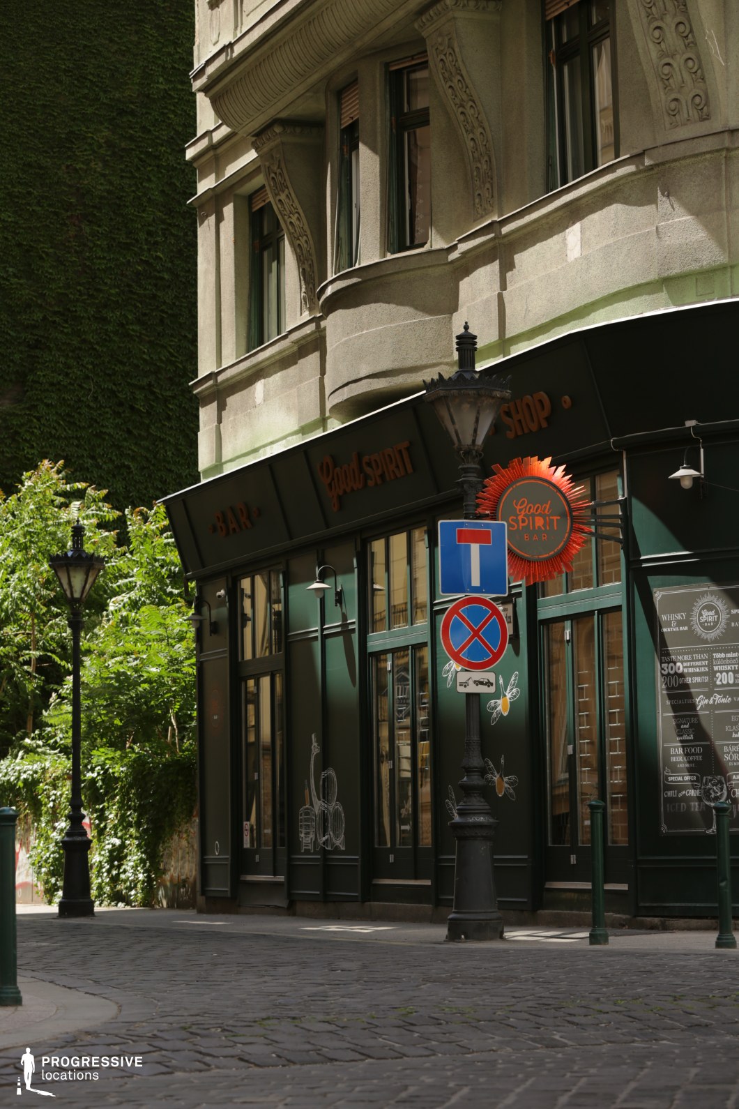 Corner bar facade with curved structure, a film and photography location featuring bold contrast and detailed storefront design