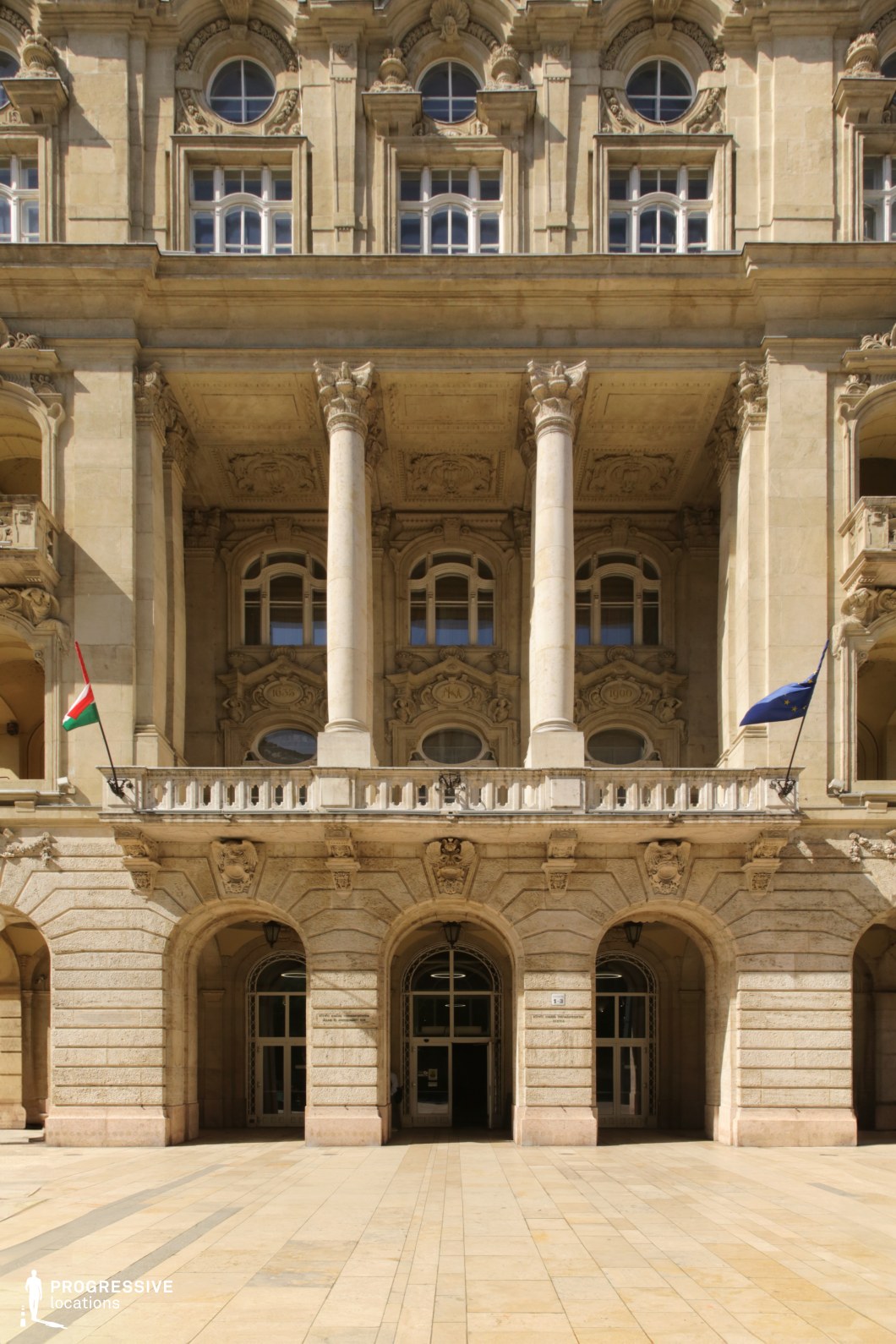 Grand facade with tall columns and arches, film and photography location with strong symmetry and monumental architectural scale